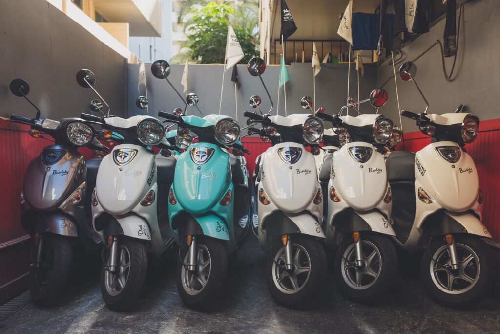 Several gas-powered Mopeds in storage lined up together, tips on how to store them
